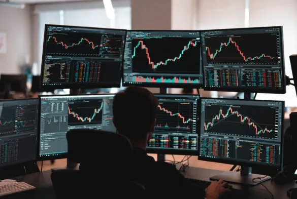 professional day trader workstation with multiple monitors and charts