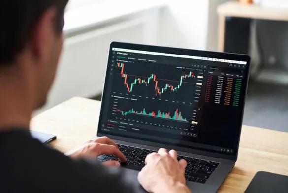 trader using online brokerage platform on laptop